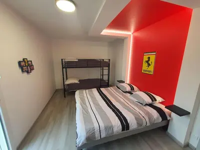 Un ou plusieurs lits dans un hébergement de l'établissement Maison à thème le Mans 66
