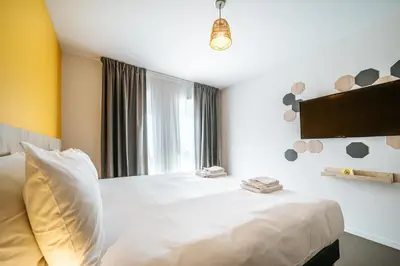 Un ou plusieurs lits dans un hébergement de l'établissement Beelodge Hotel Blois Centre