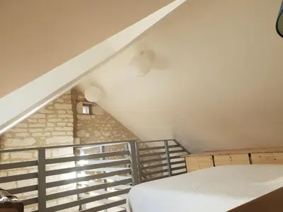 Un ou plusieurs lits dans un hébergement de l'établissement Guest house champêtre et lumineuse en tuffeau
