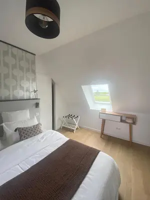 Un ou plusieurs lits dans un hébergement de l'établissement Les chambres d'hôtes du petit bois