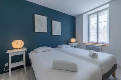 Un ou plusieurs lits dans un hébergement de l'établissement L'oberlin charmante maisonnette