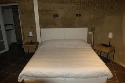 Un ou plusieurs lits dans un hébergement de l'établissement Rocaminori Hôtel