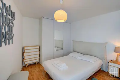 Un ou plusieurs lits dans un hébergement de l'établissement Le Lilas - 2 chambres - parking
