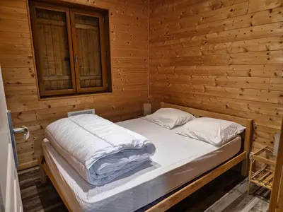 Un ou plusieurs lits dans un hébergement de l'établissement Les Cottages de Charme