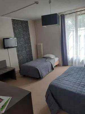 Un ou plusieurs lits dans un hébergement de l'établissement Hôtel de France