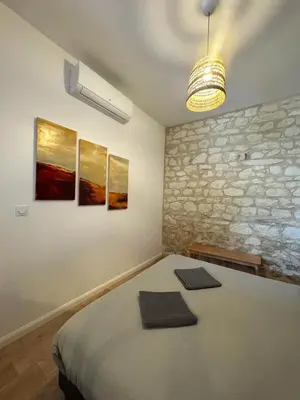 Un ou plusieurs lits dans un hébergement de l'établissement Studio Lumière - Pause lumineuse à 5 min du Zoo