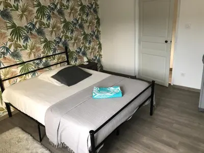Un ou plusieurs lits dans un hébergement de l'établissement Grande chambre côté jardin