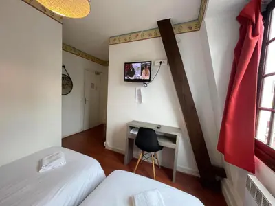 Un ou plusieurs lits dans un hébergement de l'établissement Chambre d'Hôtel Les Trois Lys