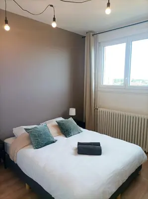 Un ou plusieurs lits dans un hébergement de l'établissement Bel appartement tout équipé