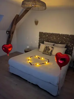 Un ou plusieurs lits dans un hébergement de l'établissement La Grange Clyna - Love Room