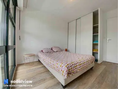 Un ou plusieurs lits dans un hébergement de l'établissement Appartement au bord du lac