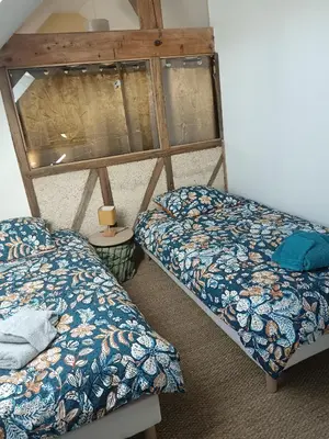 Un ou plusieurs lits dans un hébergement de l'établissement Gîte de l'oeillet