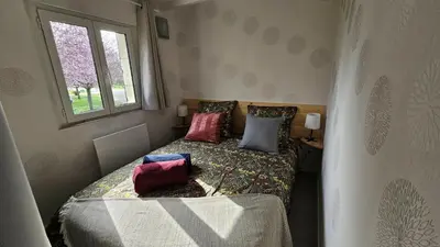 Un ou plusieurs lits dans un hébergement de l'établissement Gîte Aux-Enverons