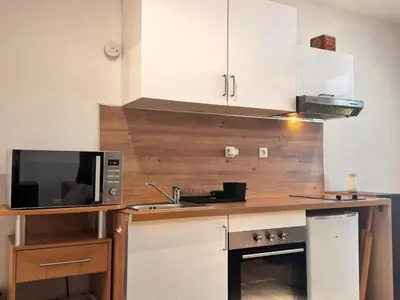 Cuisine ou kitchenette dans l'établissement L'Escapade du Port