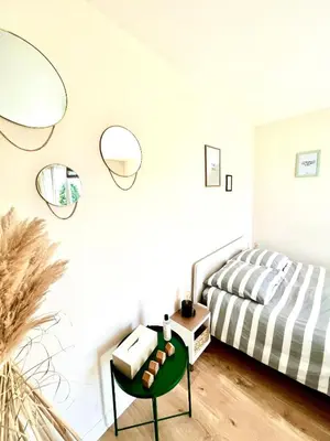 Un ou plusieurs lits dans un hébergement de l'établissement Cocooning appartement