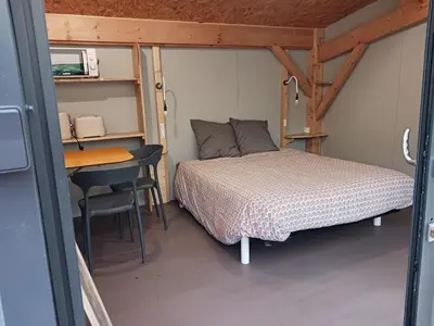Un ou plusieurs lits dans un hébergement de l'établissement Studio de l'étang