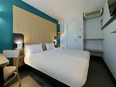 Un ou plusieurs lits dans un hébergement de l'établissement B&B HOTEL Le Mans Nord 2