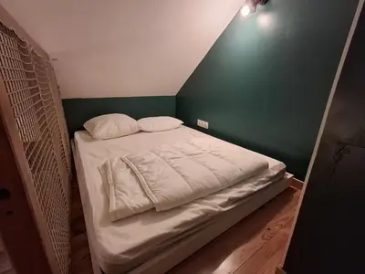 Un ou plusieurs lits dans un hébergement de l'établissement Petite maison au fond du jardin