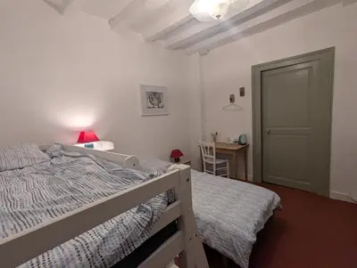 Un ou plusieurs lits dans un hébergement de l'établissement Le Tintamarre - Chambres et suite familiale à 5 min du Zoo de Beauval