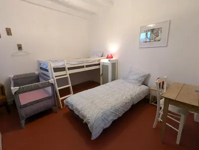 Un ou plusieurs lits dans un hébergement de l'établissement Le Tintamarre - Chambres et suite familiale à 5 min du Zoo de Beauval