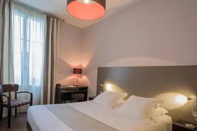 Un ou plusieurs lits dans un hébergement de l'établissement Hôtel Ronsard
