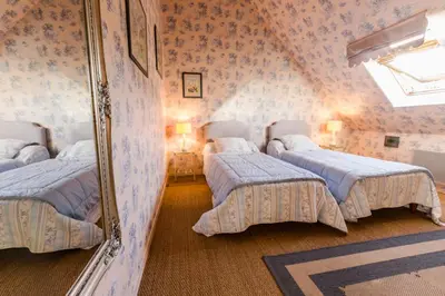 Un ou plusieurs lits dans un hébergement de l'établissement Chambres d'hôtes La Ferme du Grand Launay