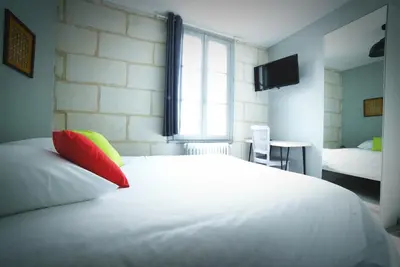 Un ou plusieurs lits dans un hébergement de l'établissement Hotel de la gare