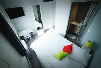 Un ou plusieurs lits dans un hébergement de l'établissement Hotel de la gare