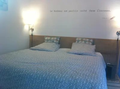 Un ou plusieurs lits dans un hébergement de l'établissement Gite 4* L'Orée des Fleurs