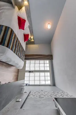 Un ou plusieurs lits dans un hébergement de l'établissement Confort Hôtel Thouars