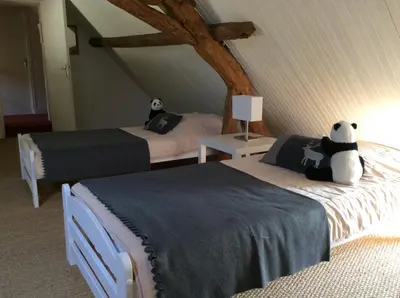 Un ou plusieurs lits dans un hébergement de l'établissement Gîte Ô Beauval