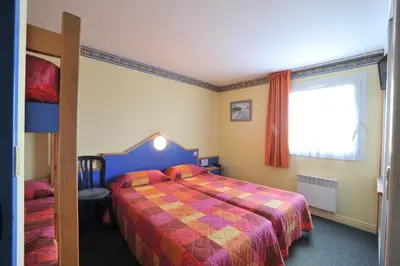 Un ou plusieurs lits dans un hébergement de l'établissement Fasthotel Vendome