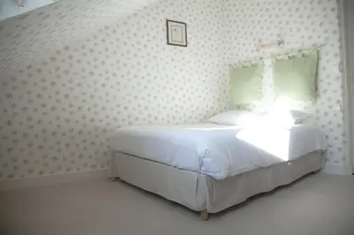 Un ou plusieurs lits dans un hébergement de l'établissement Hôtel Du Manoir