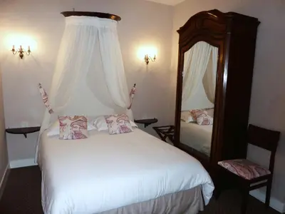 Un ou plusieurs lits dans un hébergement de l'établissement Hôtel Du Manoir