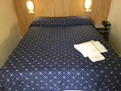 Un ou plusieurs lits dans un hébergement de l'établissement Hôtel Noctuel Blois Sud