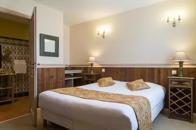 Un ou plusieurs lits dans un hébergement de l'établissement Hôtel & Spa du Domaine des Thômeaux, The Originals Relais