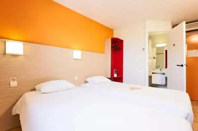 Un ou plusieurs lits dans un hébergement de l'établissement Premiere Classe Tours Sud - Chambray Lès Tours