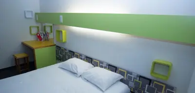 Un ou plusieurs lits dans un hébergement de l'établissement hôtel QUICK Palace Tours Nord