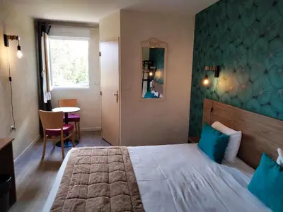 Un ou plusieurs lits dans un hébergement de l'établissement Hotel Au Sans Souci