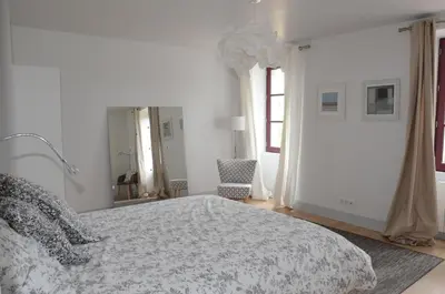 Un ou plusieurs lits dans un hébergement de l'établissement Gite La Maison Blanche Familiale Château La Roche Racan