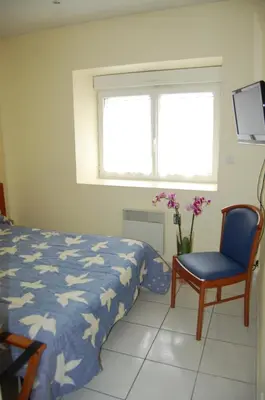 Un ou plusieurs lits dans un hébergement de l'établissement Appart'hôtel La Suze sur Sarthe