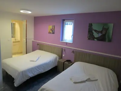 Un ou plusieurs lits dans un hébergement de l'établissement Hotel le Faisan