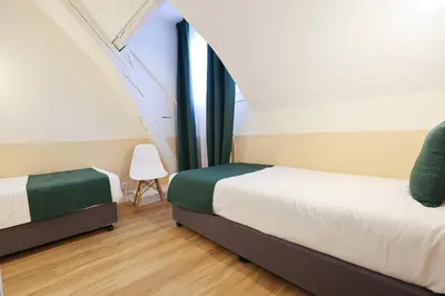 Un ou plusieurs lits dans un hébergement de l'établissement Grand Hôtel Saint-Aignan