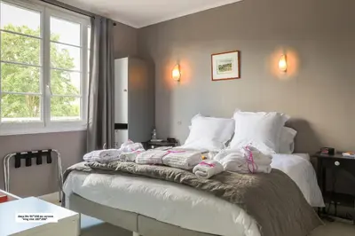 Un ou plusieurs lits dans un hébergement de l'établissement Maison 88 m2 le patio du centre ville avec garage