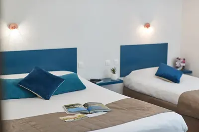 Un ou plusieurs lits dans un hébergement de l'établissement Hotel De La Pommeraie