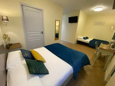 Un ou plusieurs lits dans un hébergement de l'établissement Hôtel Relais du Loir