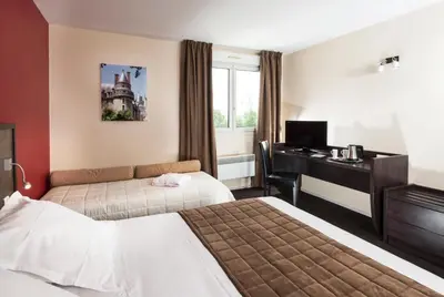 Un ou plusieurs lits dans un hébergement de l'établissement Kyriad Tours - Joué-Lès-Tours