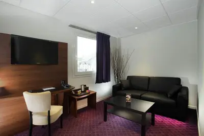 Coin salon dans l'établissement Brit Hotel Tours Sud – Le Cheops