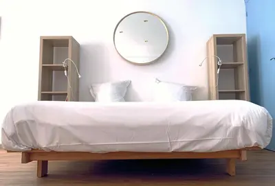 Un ou plusieurs lits dans un hébergement de l'établissement La Chambre Bleue