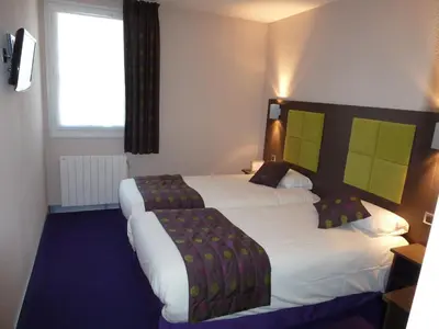 Un ou plusieurs lits dans un hébergement de l'établissement Tourhotel Blois